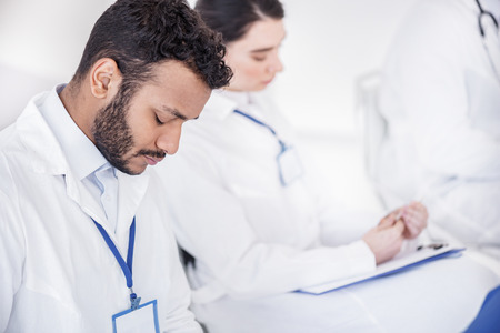 Pensive physician making abstract in hospitalの写真素材