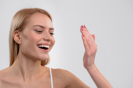 Young woman is satisfied with skincare treatmentの写真素材