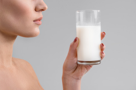 Girl drinking white dairy beverageの写真素材