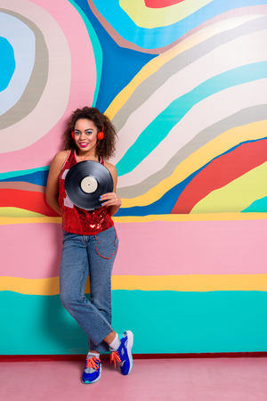 Outgoing woman hearing song through headsetの写真素材