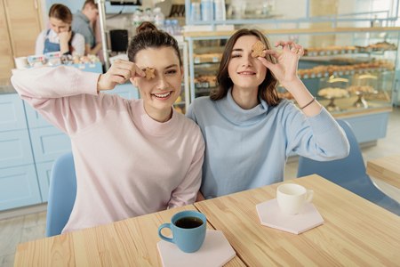 Cheerful young women in confectioneryの写真素材