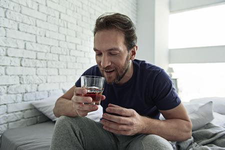 Pleased male person keeping alcoholの写真素材