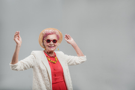 Cheerful modern middle aged female having fun timeの写真素材