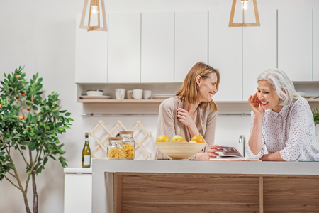 Friendly family viewing photos at homeの写真素材