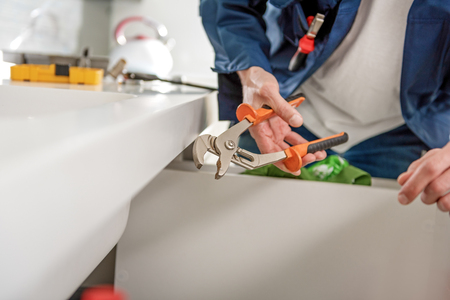 Man using tool for upkeepの写真素材