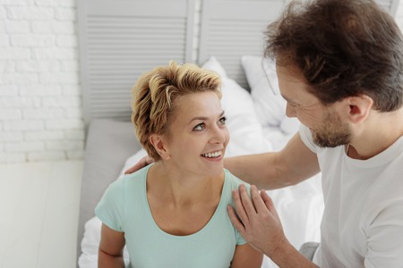 Cheerful husband and wife relaxing at homeの写真素材