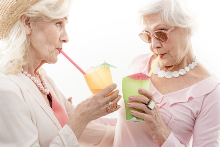 Old women tasting alcohol beverageの写真素材