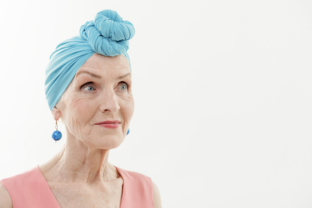 Happy old woman in fashionable clothesの写真素材