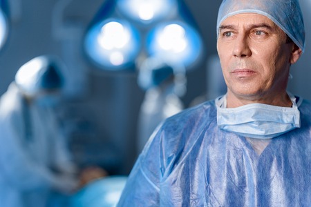 Sad doctor in protective uniformの写真素材