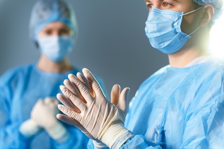 Concentrated doctors dressed in surgical uniformの写真素材