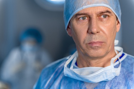 Sad male surgeon glancing despondentlyの写真素材