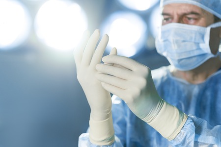 Concentrated surgeon dressed in protective uniformの写真素材