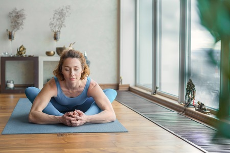 Skillful female yogi flexing her bodyの写真素材
