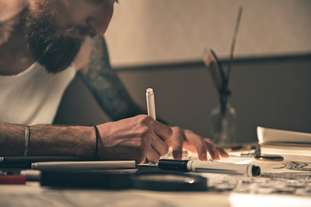 Serene man drawing image at deskの写真素材