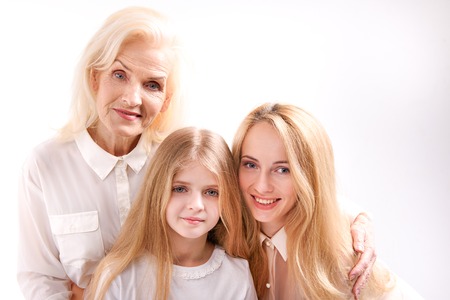 Three cheerful female persons looking at camera