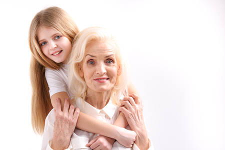 Small girl embracing old womanの写真素材