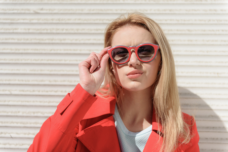 Cool young woman posing with eyeglassesの写真素材