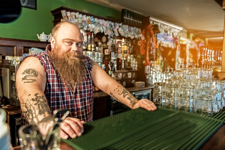 Cheerful fat tapster working in boozerの写真素材