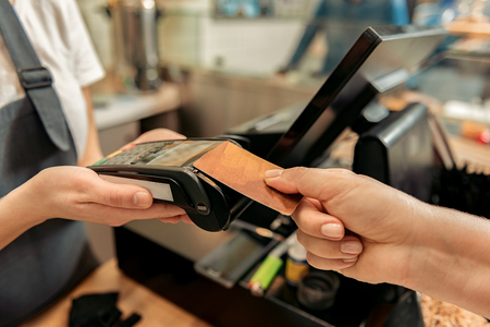 Woman giving payment for products in shop