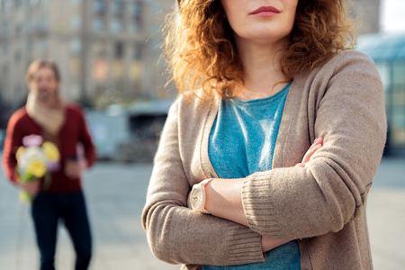 Insulted lady waiting for her boyfriend on streetの写真素材