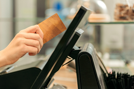 Saleswoman receiving payment in shopの写真素材