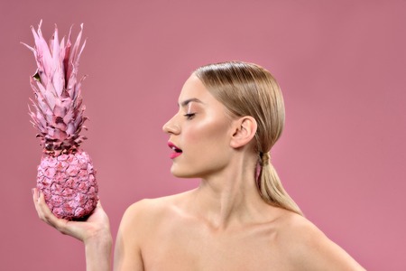 Pretty girl standing with color ananasの写真素材