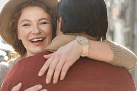 Cheerful loving couple embracing with fondnessの写真素材