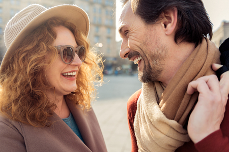 Joyful man and woman talking outdoorsの写真素材
