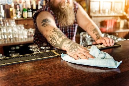 Man arm wiping counter in beerhouseの写真素材