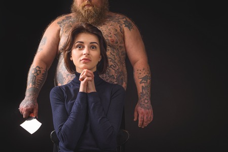 Terrified woman is going to be eaten by fatsoの写真素材