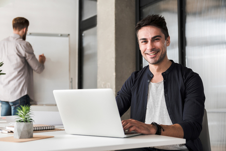 Happy smiling male manager workingの写真素材
