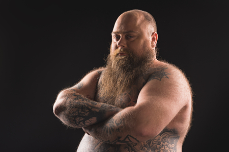 Thick tattooed guy expressing seriousnessの写真素材