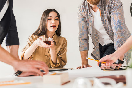 Curious female manager among colleaguesの写真素材
