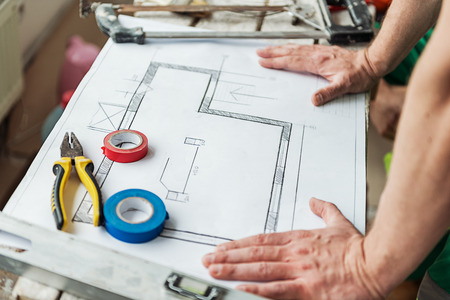 Builder putting arms on planの写真素材