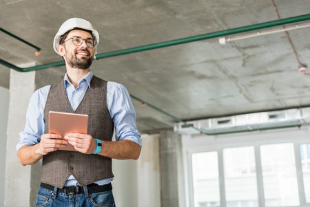 Jolly smiling constructor keeping tabletの写真素材