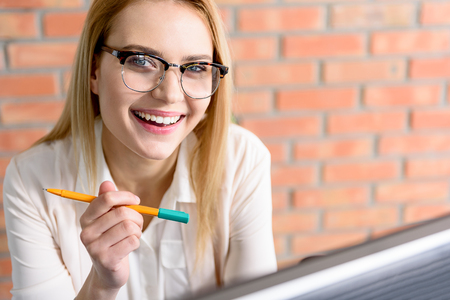 Charming girl looking at camera with happinessの写真素材