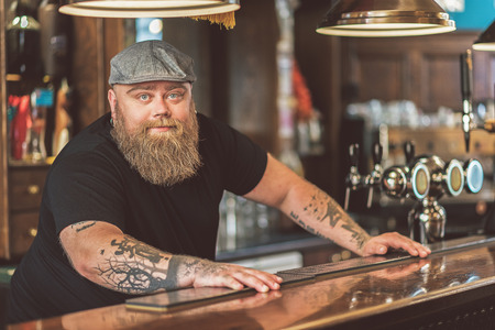Bearded adult guy working in pubの写真素材