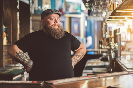 Tattooed barman working in pubの写真素材