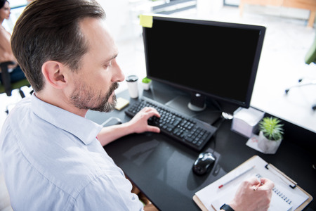 Serious busy office worker making notes