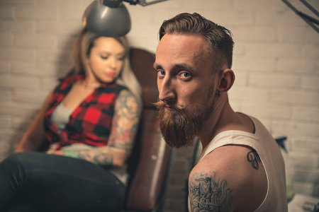 Man working in tattoo salonの写真素材