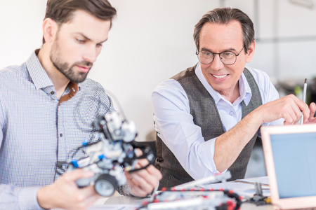 Cheerful men sitting at workplace
