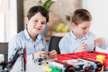 Cheerful male children in workshopの写真素材