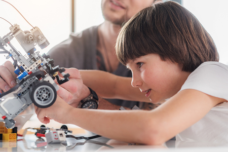 Concentrated male kid repairing technical toyの写真素材
