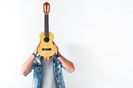 Male guitarist holding musical instrumentの写真素材