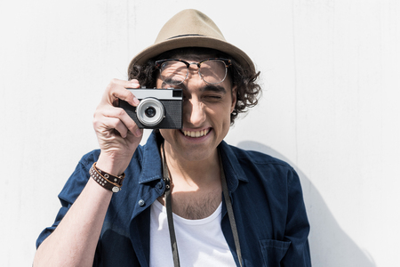 Joyful trendy teenager making photo with smileの写真素材