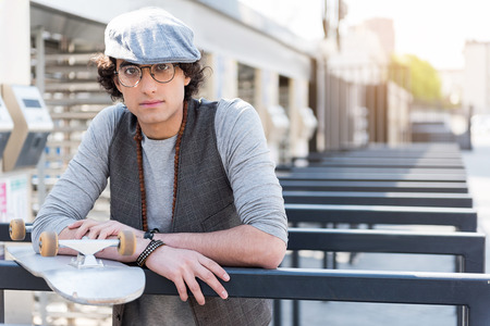 Stylish pensive teenager resting outdoorsの写真素材