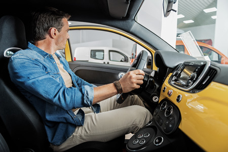 Serene man driving new vehicle