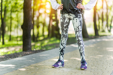 Aged well-shaped lady practicing on park sidewalkの写真素材