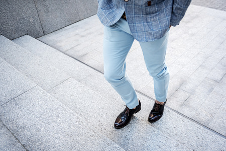 Stylish male person overcoming ladderの写真素材