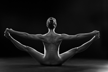 Naked young lady making exerciseの写真素材